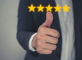 Customer review good rating concept hand pressing five star on visual screen and positive customer feedback testimonial