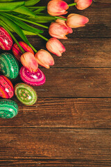 Colorful Easter eggs on wooden background. Happy Easter. Space for text.