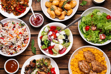 Buffet service. Many different dishes on wooden table, flat lay