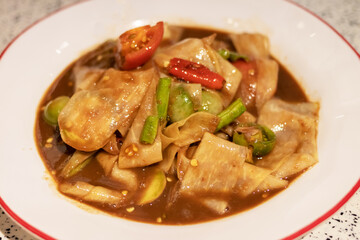 Papaya Salad or Somtam in Luang Prabang green papaya is thinly sliced and they add fermented fish sauce (pla ra) as well. 