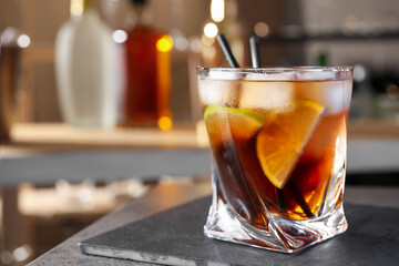 Cuba Libre cocktail on table in bar. Space for text