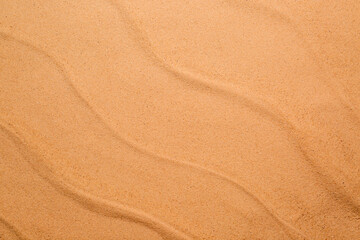 Fototapeta na wymiar Beige clean beach sand as background, top view. Summer vacation