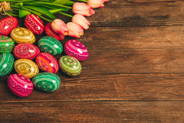 Colorful Easter eggs on wooden background. Happy Easter. Space for text.