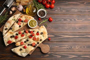 Flat lay composition with focaccia bread on wooden table. Space for text