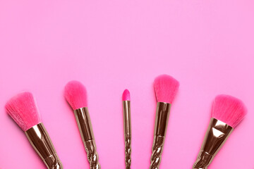 Set of makeup brushes on pink background, flat lay. Space for text