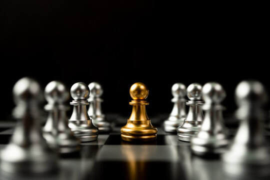 Golden Chess pawn standing to Be around of other chess, Concept of a leader must have courage and challenge in the competition, leadership and business vision for a win in business games