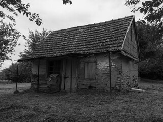 Abandoned traditional house with earthen walls in countryside in ruined shape