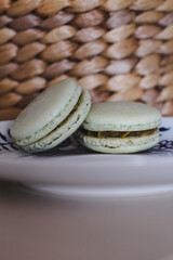 Pistachio macaroons on a wooden background