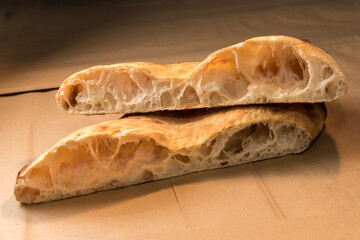 Baked focaccia - bread of sourdough - Close up of cut loaf showing the alveoli as test of gluten...