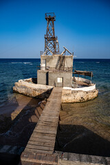 Fototapeta na wymiar vintage pier and lighthouse in the Red Sea on a sunny day