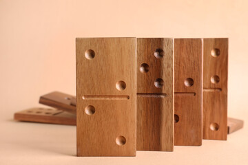 Wooden domino tiles with pips on beige background