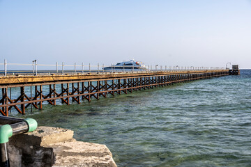old pier at the lighthouse in the Red Sea on a sunny day against the blue sky