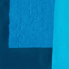 Blue torn paper collage close-up. Texture made from various paper and cardboard parts. Damaged old paper background. Vintage blank wallpaper. Material design backdrop.