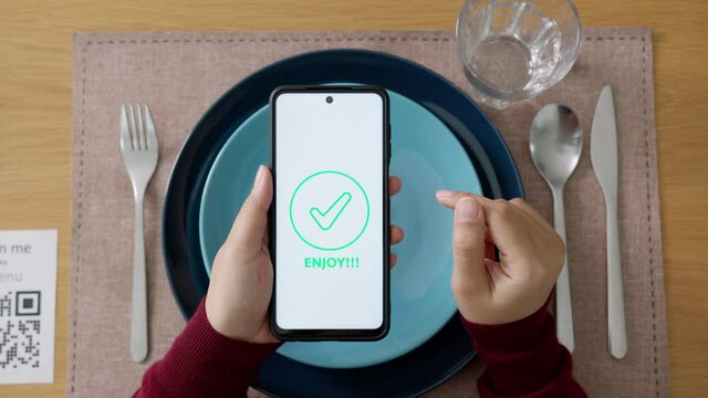 Hand's customer scan QR code for online menu service at table in restaurant during pandemic coronavirus. New normal contactless technology lifestyle protection coronavirus pandemic in restaurant