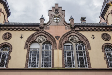 Fototapeta na wymiar Fragments of old building of Circle Catholic Saint-Martin, created in 1880 - 72-meter-long building combines neo-Romanesque and neo-gothic styles. Colmar, Alsace, France.