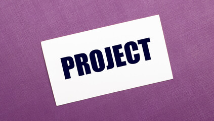 On a lilac background, a white card with the word PROJECT