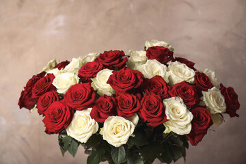 Luxury bouquet of fresh roses on beige background, closeup