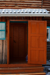 Veranda of an old country house, with a red door