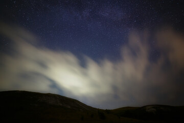 Fototapeta na wymiar Bright stars in the night sky with clouds.
