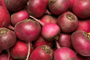 Pile of red turnips as background, top view