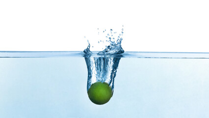 Lime falling down into clear water against white background
