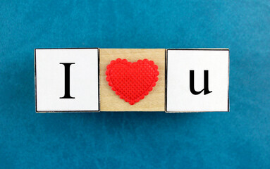 The inscription "I love you" wooden cubes on a turquoise background