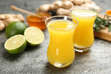 Immunity boosting drink and ingredients on grey table, closeup