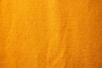 Golden yellow background from a textile material with pattern, closeup.