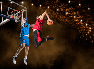 Obraz na płótnie Canvas Two basketball players in arena. Blocked shot