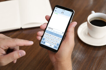 Man sending message with text I Love You, closeup