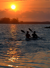 silhouette of a person in a kayak