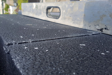 Fototapeta premium Warming of houses by black plates from polyfoam. Protection of apartments from moisture and dampness.