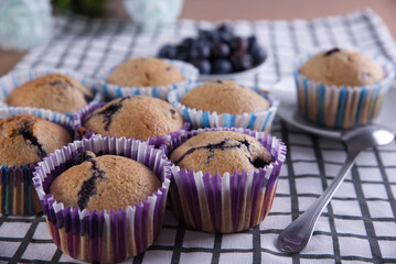Delicious homemade cupcakes filled with blueberries and presented in small molds.