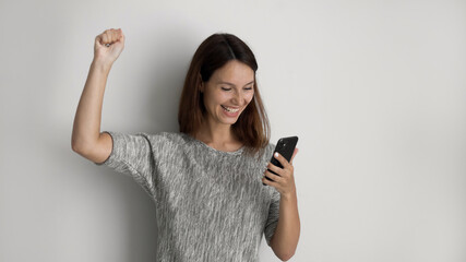 Banner panoramic view of excited millennial Caucasian woman isolated on grey studio background...
