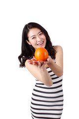 Young woman in a striped dress holding orange