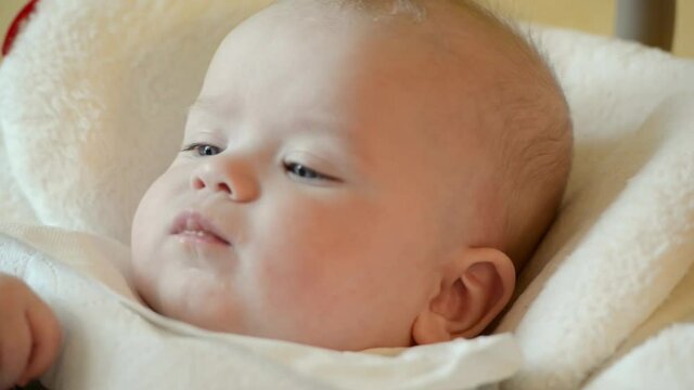 Cute baby eats from a spoon mom feeds, food, nutrition, childhood concepts