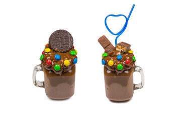 Chocolate milkshake with whipped cream, cookies, waffles, served in glass mason jar. 