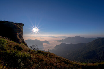 Naklejka premium Beautiful natural landscape on the hilltop with the winter sunrise at Phu Chi Fa Viewpoint, Chiang Rai, Thailand.