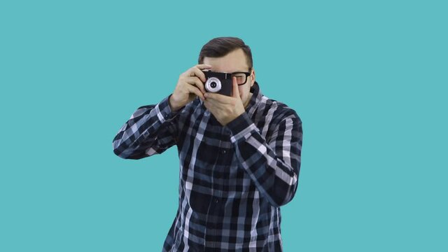 A young male photographer takes pictures with an old camera
