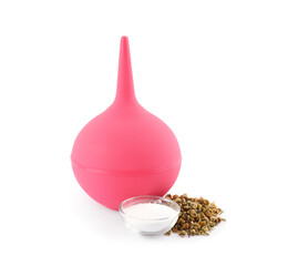 Pink enema, soda powder and dry chamomile flowers on white background