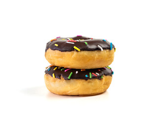 A stack of chocolate flavoured donut with sprinkles on white background. two black doughnut...