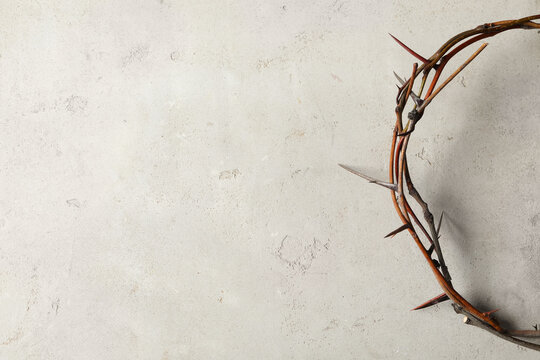 Crown of thorns on light background, top view with space for text. Easter attribute