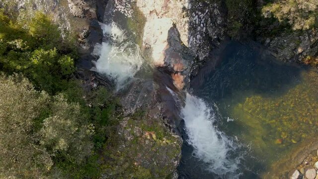 Aerial view of a mountain stream cascading into a clear pool at Pirio near Manso in the Fango Valley of Corsica