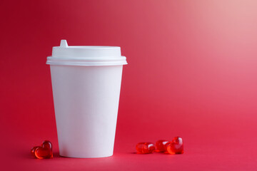 One white coffee cup with hearts on a red background. Mockup. Horizontal format. Copyspace