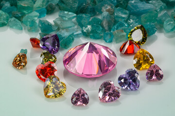 pink sapphires diamonds are placed in an enclave of heart shaped diamonds on raw sky blue...