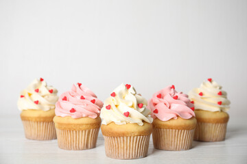 Tasty sweet cupcakes on white table. Happy Valentine's Day