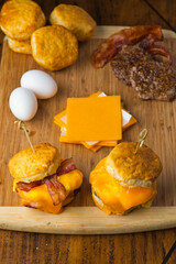 Breakfast sandwich or BLT. Toasted bread topped with eggs, sausage, bacon, ham, beef, cheese, sour cream, salsa and guacamole. Classic American restaurant or diner breakfast favorite.