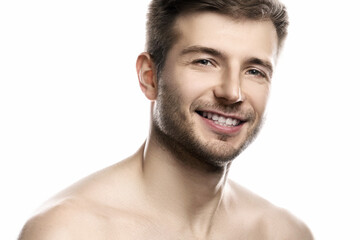 Obraz premium Young and handsome man with smooth skin on white background