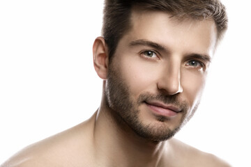 Naklejka premium Young and handsome man with smooth skin on white background