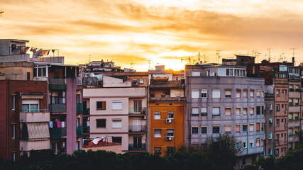 The sun dominates a traditional neighborhood in Barcelona. The warm colors give a welcoming effect.